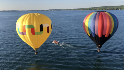 Two balloons fly side by side over Canandaigua Lake Balloon flying over the Finger Lakes